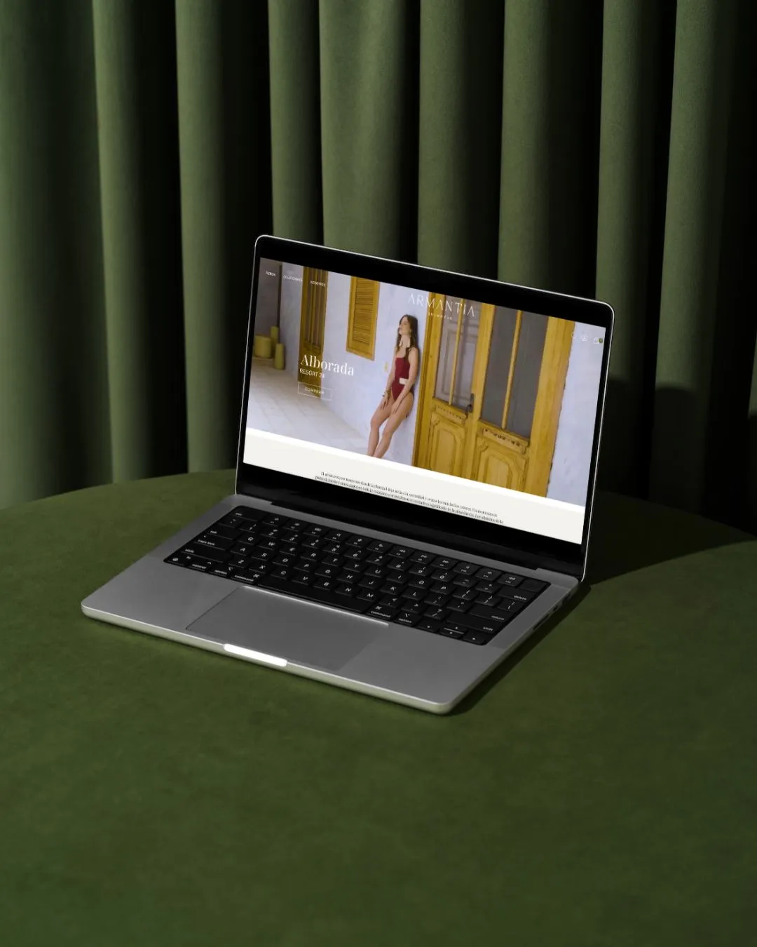 Armantia website on a laptop on green velvet