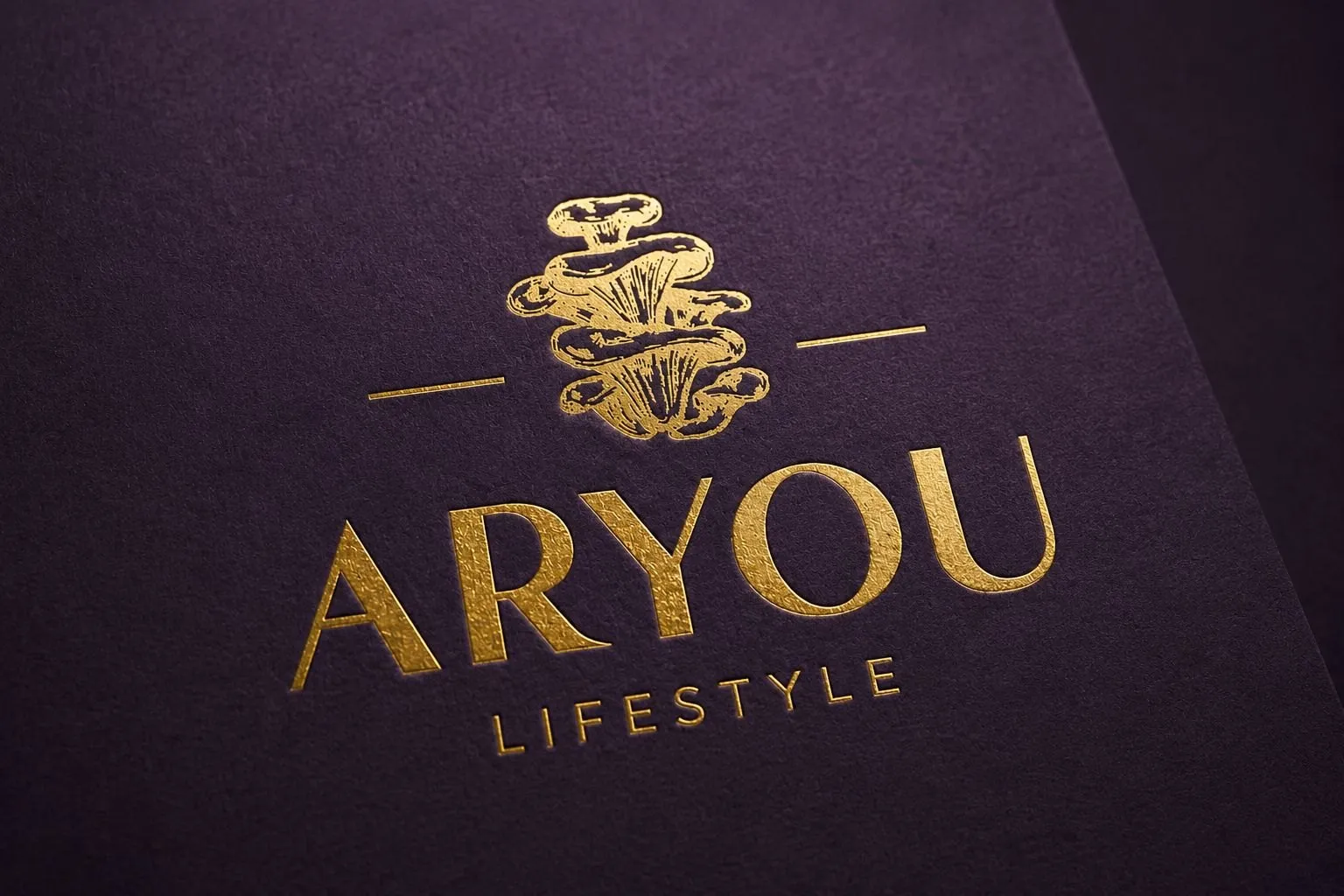 Gold foil logo on purple paper